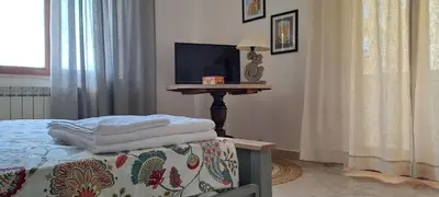 a bedroom with a bed and a table with towels at Casa di Nat in Palermo
