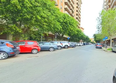 a row of cars parked on the side of a street at Casa di Nat in Palermo