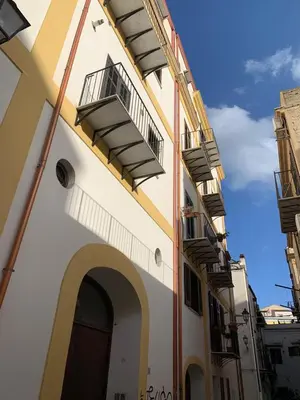 a building with balconies on the side of it at CentruMassimo Apartment in Palermo