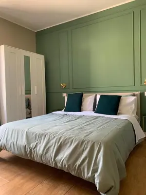 a bedroom with a large bed with blue and white pillows at CentruMassimo Apartment in Palermo