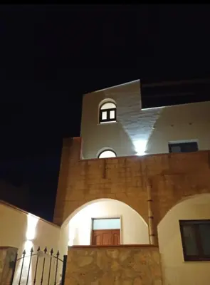 a building with a clock tower at night at Un tocco di San Vito in San Vito lo Capo