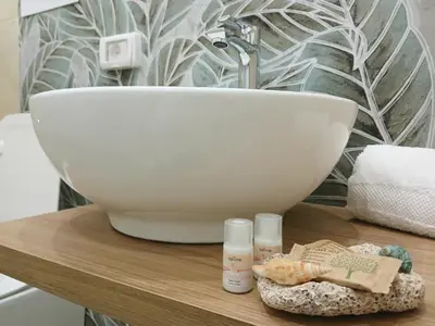 a bathroom counter with a sink and a white bowl at Un tocco di San Vito in San Vito lo Capo