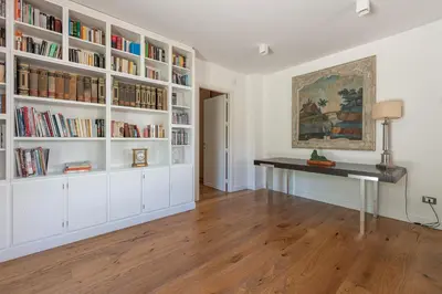 a room with a desk and bookshelves at Villa Nika in Palermo