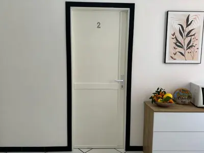 a table with a plate of food and a vase at Angolo Lamia Sicily Apartment in Partinico