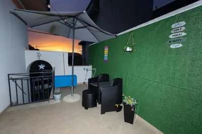 a green wall with two black chairs in a room at STELLA BLU in Calatafimi