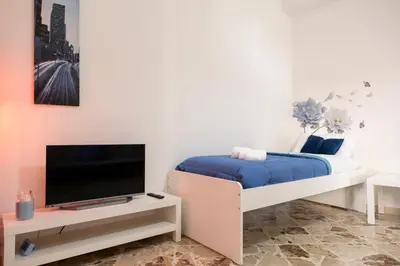 a bedroom with a bed and a tv on a stand at STELLA BLU in Calatafimi
