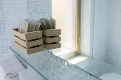 a glass counter with wooden boxes on it in a bathroom at STELLA BLU in Calatafimi
