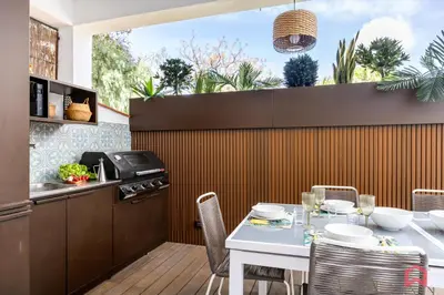 a kitchen and dining room with a table and chairs at Appartamento in villa con piscina privata in Palermo