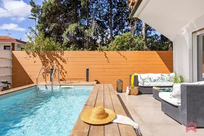 a hat sitting on a table next to a swimming pool at Appartamento in villa con piscina privata in Palermo