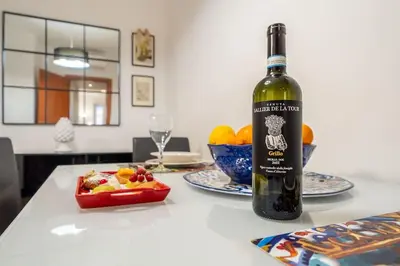 a bottle of wine sitting on top of a table at [MoroHouse] 50mt from Teatro Massimo in Palermo
