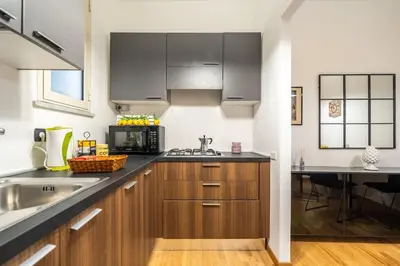 a kitchen with wooden cabinets and a counter top at [MoroHouse] 50mt from Teatro Massimo in Palermo