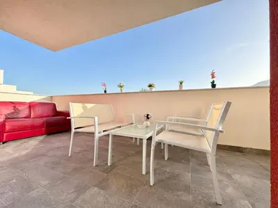 a living room with a table and two chairs at Attico Magnificent [Wi-Fi/Free Parking] in Palermo