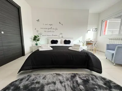a bedroom with a large black bed in a room at Attico Magnificent [Wi-Fi/Free Parking] in Palermo