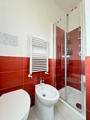 a red bathroom with a toilet and a shower at Attico Magnificent [Wi-Fi/Free Parking] in Palermo