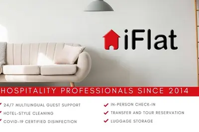 a white couch in a room with a red house sticker at iFlat Normanni Lounge Apartment in Palermo