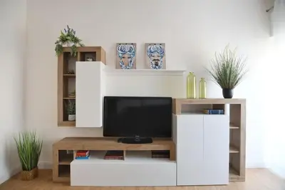 a white entertainment center with a tv in a living room at iFlat Normanni Lounge Apartment in Palermo