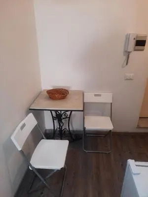 a small table with two chairs and a basket on it at EMILY'S HOUSE in Palermo
