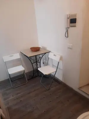 a small table and two chairs in a room at EMILY'S HOUSE in Palermo