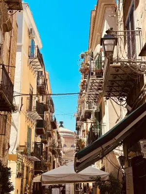 a city street with buildings and umbrellas at Monteleone rooms in Palermo