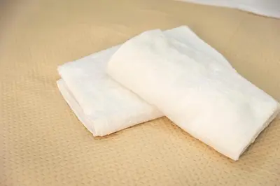 a white towel sitting on top of a bed at Casa Vacanze Deianira in Santa Flavia
