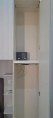 a kitchen with a cabinet with a clock on a shelf at Casa Vacanze Altea in Santa Flavia