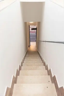 a staircase in a building with white walls at Casa Vacanze Altea in Santa Flavia