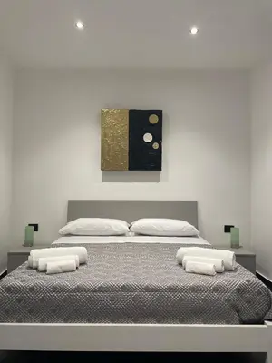 a bedroom with a large bed with two pillows at Casa Vacanze Donna MariaCarme' in Palermo