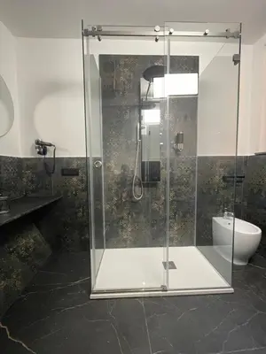 a glass shower in a bathroom with a toilet at Casa Vacanze Donna MariaCarme' in Palermo