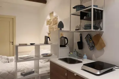 a kitchen with a sink and a counter top at Casuzza palazzo storico, Stazione Centrale Palermo in Palermo