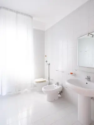 a white bathroom with a toilet and a sink at Villa Moon Total Relax in Alcamo