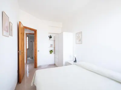 a white room with a bed and a hallway at Villa Moon Total Relax in Alcamo