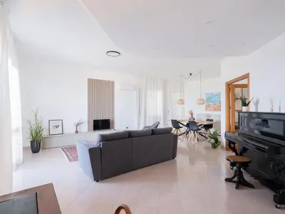 a living room with a couch and a piano at Villa Moon Total Relax in Alcamo