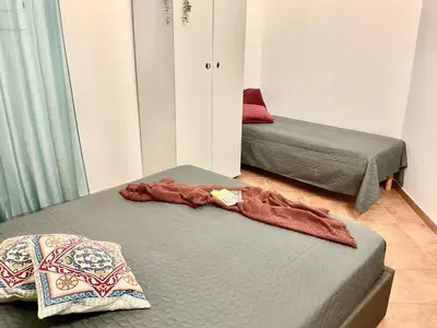 a room with two beds and a blanket on a bed at Vista sul mare e splendido terrazzo in Castellammare del Golfo
