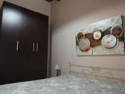 a bedroom with a bed and a painting on the wall at Vista sul mare e splendido terrazzo in Castellammare del Golfo