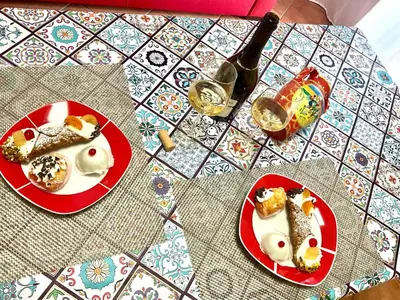 a table with two plates of food on it at Vista sul mare e splendido terrazzo in Castellammare del Golfo