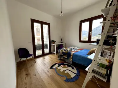 a bedroom with a bunk bed and a ladder at Casa sul Mare alle porte di Palermo in Isola delle Femmine