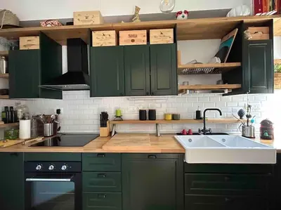 a kitchen with green cabinets and a sink at Casa sul Mare alle porte di Palermo in Isola delle Femmine