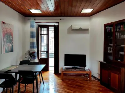 a living room with a table and a television at Capo Seralcadio in Palermo