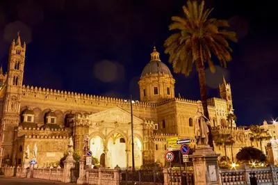 a large building with a palm tree in front of it at Capo Seralcadio in Palermo