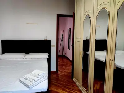 a bedroom with a bed and a mirror with towels on it at Capo Seralcadio in Palermo