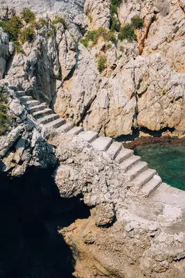a stone staircase on the side of a rocky mountain at Sant'Elia Luxury Home&Spa con accesso al mare in Santa Flavia