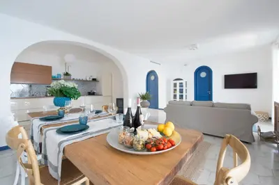 a living room with a table with a plate of fruit at Sant'Elia Luxury Home&Spa con accesso al mare in Santa Flavia