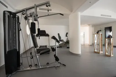 a gym with treadmills and cardio equipment in a room at Sant'Elia Luxury Home&Spa con accesso al mare in Santa Flavia