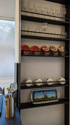 a refrigerator filled with plates and bowls on shelves at Don Armando al Massimo in Palermo
