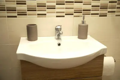 a bathroom sink with two cups on top of it at La Maison Du Centre in Palermo