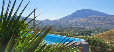 a swimming pool with a view of a mountain at Villa Ballerina Bianca in Scopello