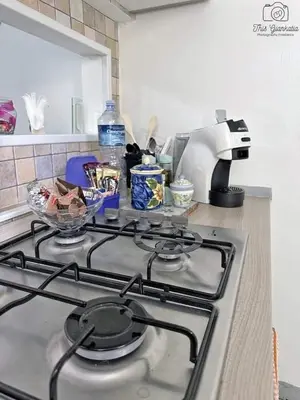 a stove top oven in a kitchen next to a counter at Sikulamente in Palermo