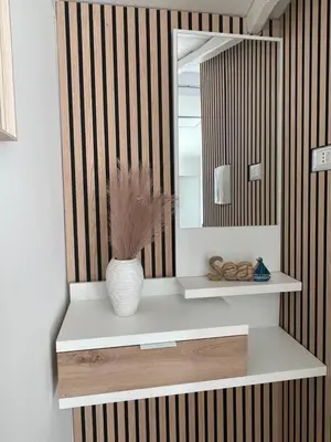 a bathroom with a mirror and a vase on a shelf at Villa Vittoria in Trappeto
