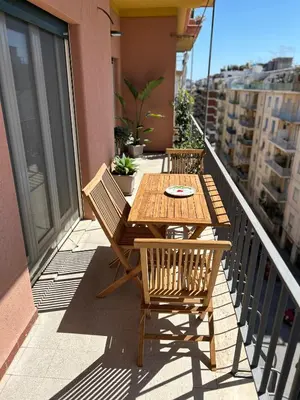 a wooden table and chairs on a balcony at SiSo Home in Palermo