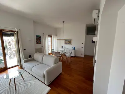 a living room with a couch and a table at SiSo Home in Palermo